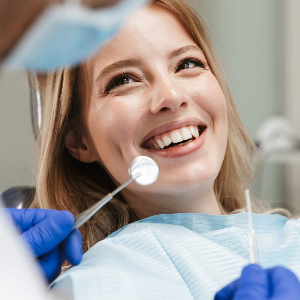 Happy patient smiling during a comfortable appointment with her dental care team