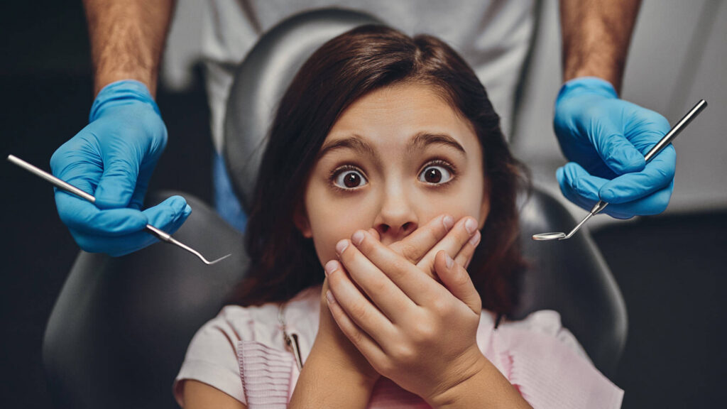 Nervous patient in a dental chair representing dentophobia and fear of dental treatment