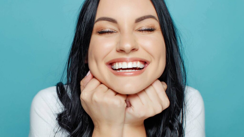 Smiling woman representing a fresh start and a healthier, more confident smile for the new year