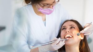 Dental hygienist professionally cleaning a patient's teeth during preventive dental care