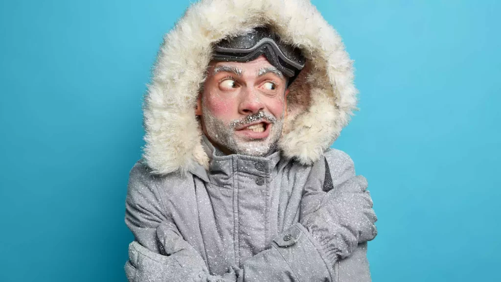 Man bundled for cold weather representing winter-related tooth sensitivity and oral health concerns