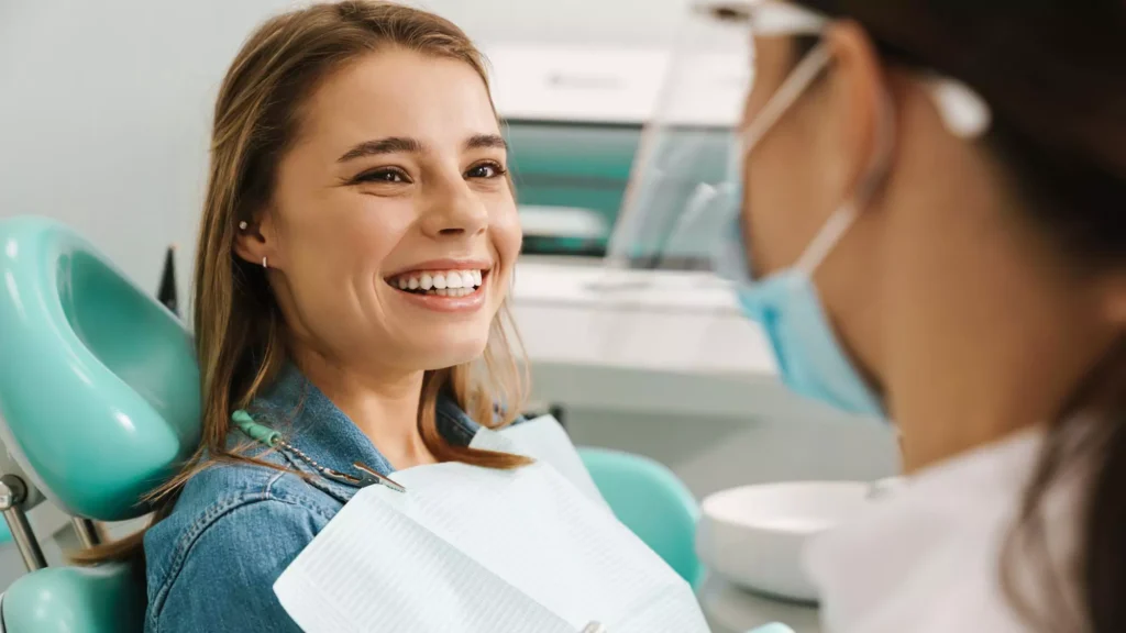 Smiling patient relaxing in a dental chair during a comfortable routine appointment