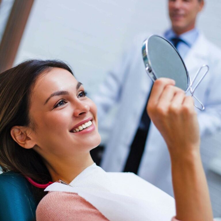 Smiling patient during a cosmetic dentistry consultation to discuss improving her smile