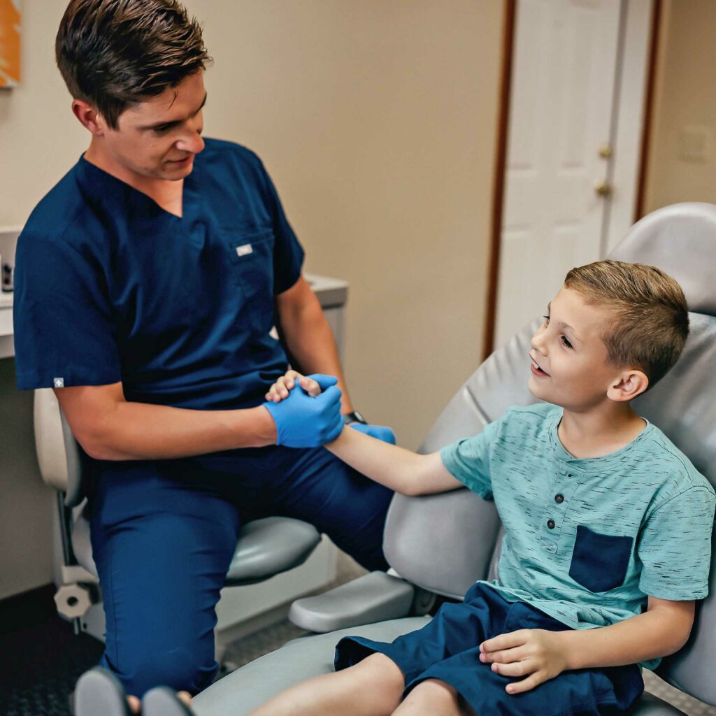 Dr. Matthew Liesen caring for a patient in a treatment room at Liesen Family Dental