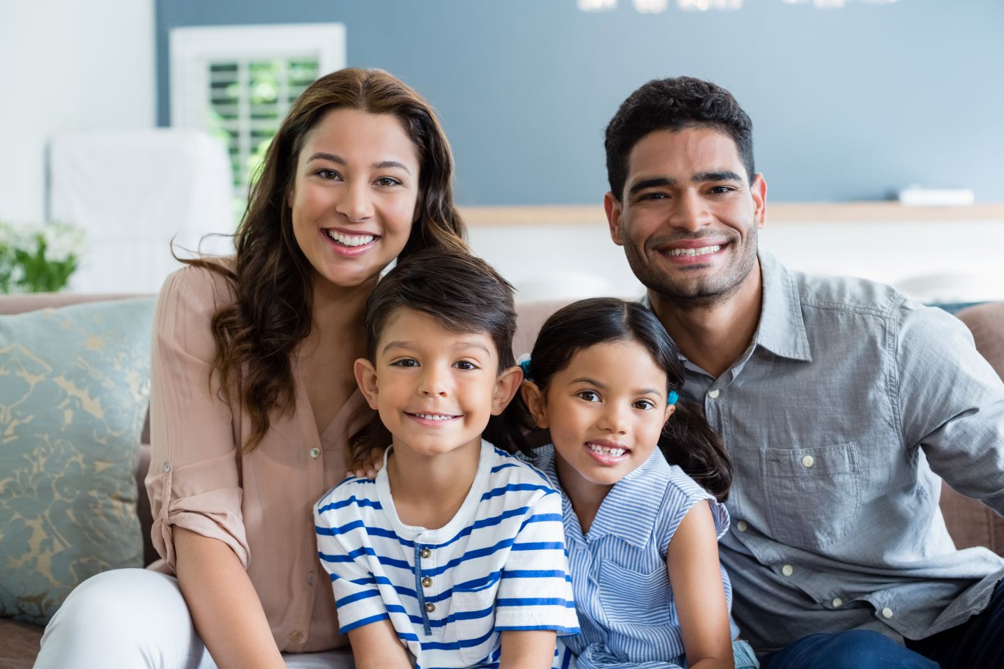 Happy family smiling together, representing healthy smiles through family dental care
