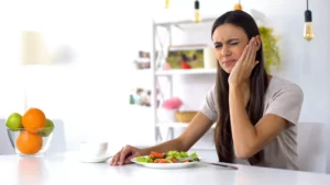 Woman experiencing tooth pain and seeking emergency dental care